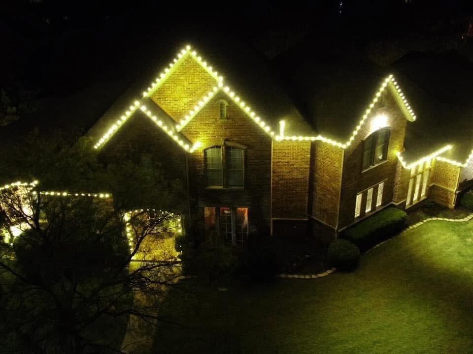 Aerial view of warm white lights on all rooflines