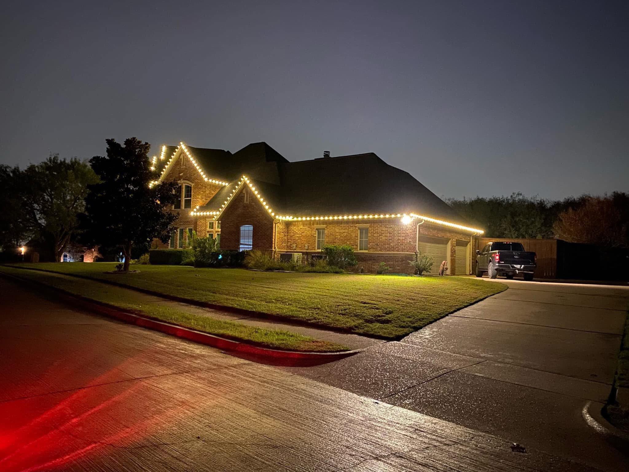 Warm white roofline lights at dusk