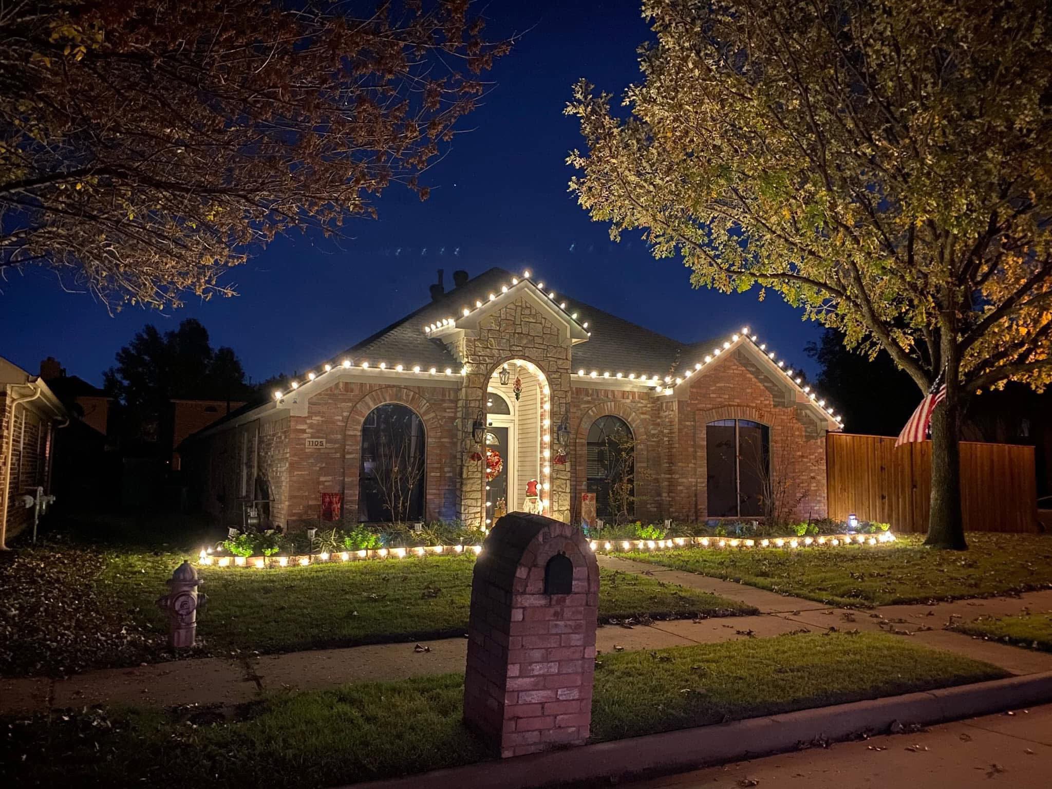 Warm white lights with luminarias along walkway